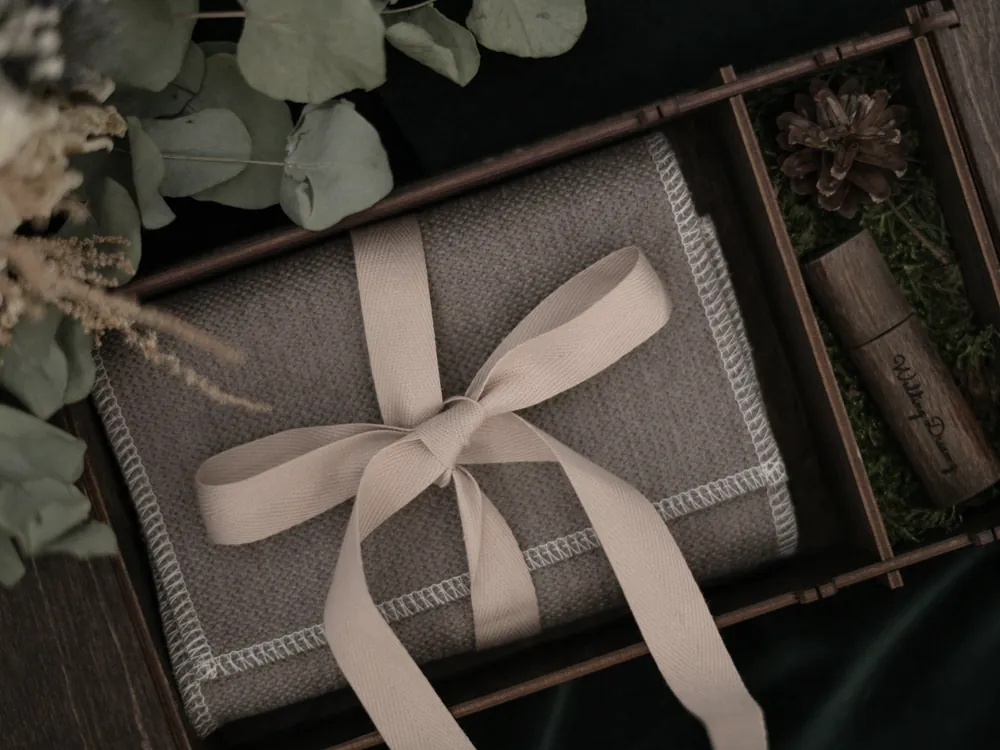 Gift box wrapped in natural paper with a satin ribbon