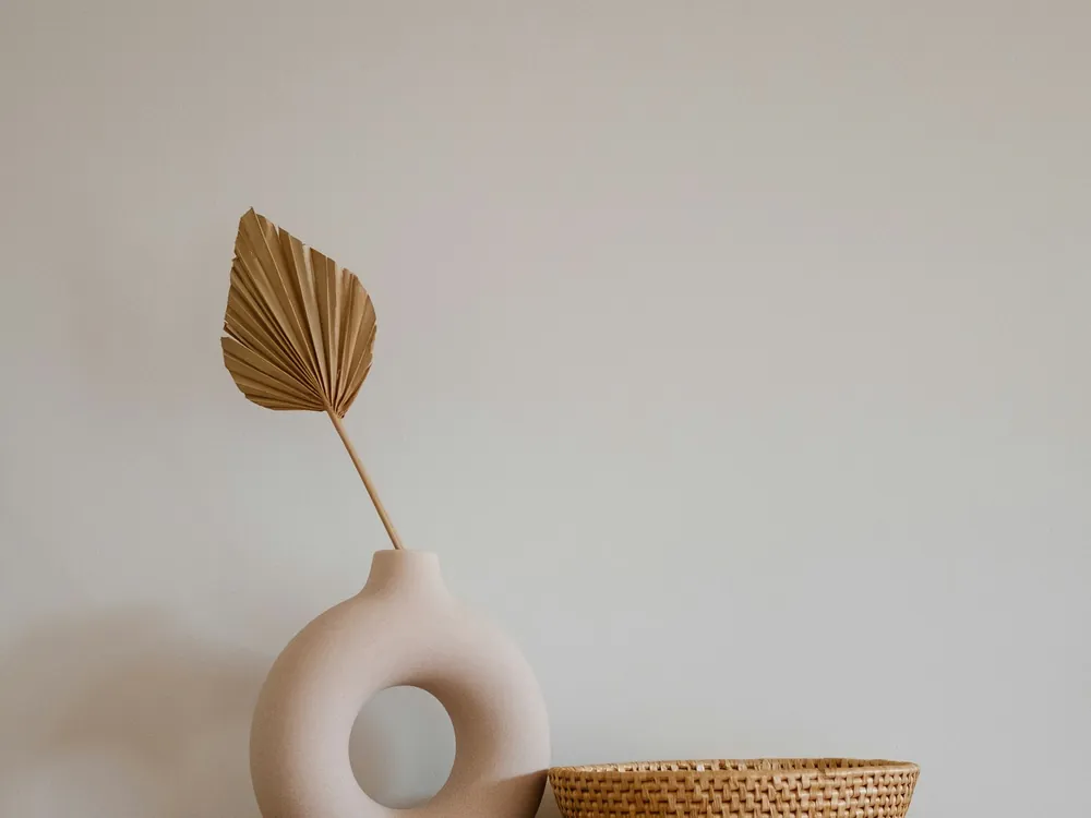 Nursery corner with a picture frame, vase and natural fibre baskets